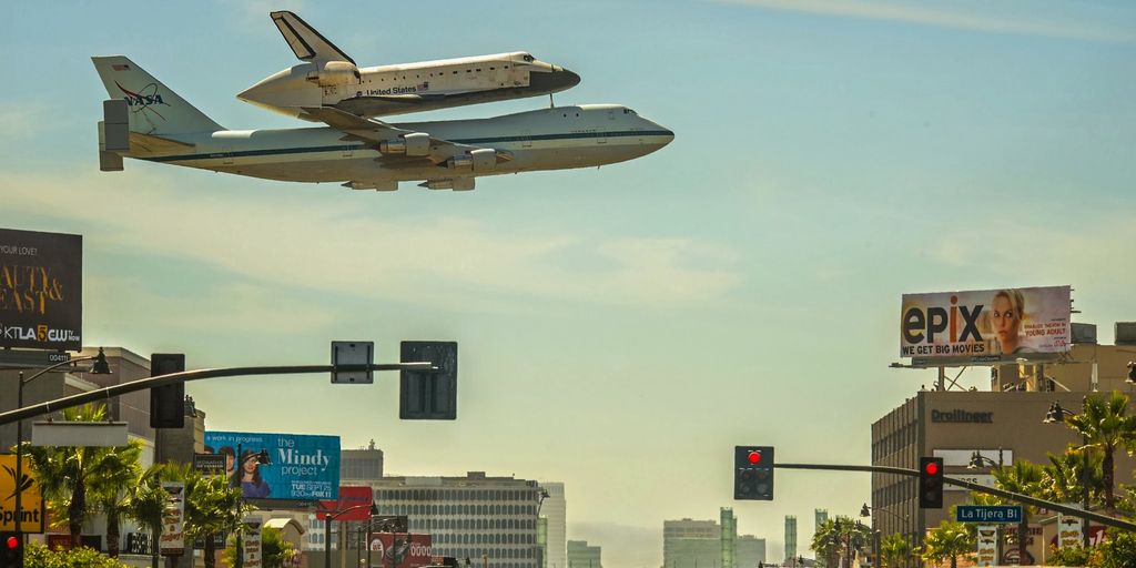 futuristic private jet flying over city skyline