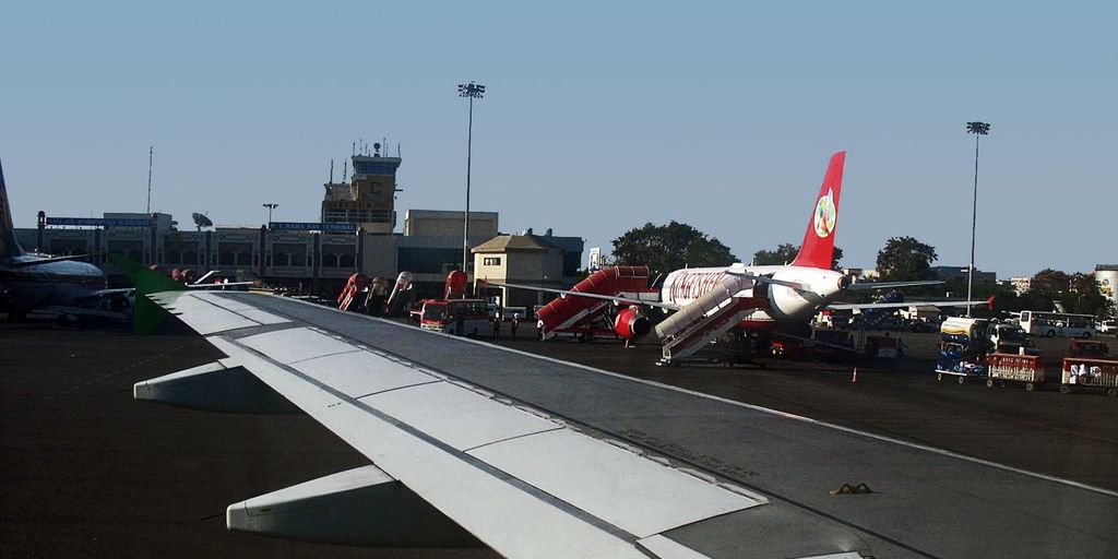 private jet on tarmac with Beverly Hills sign in background
